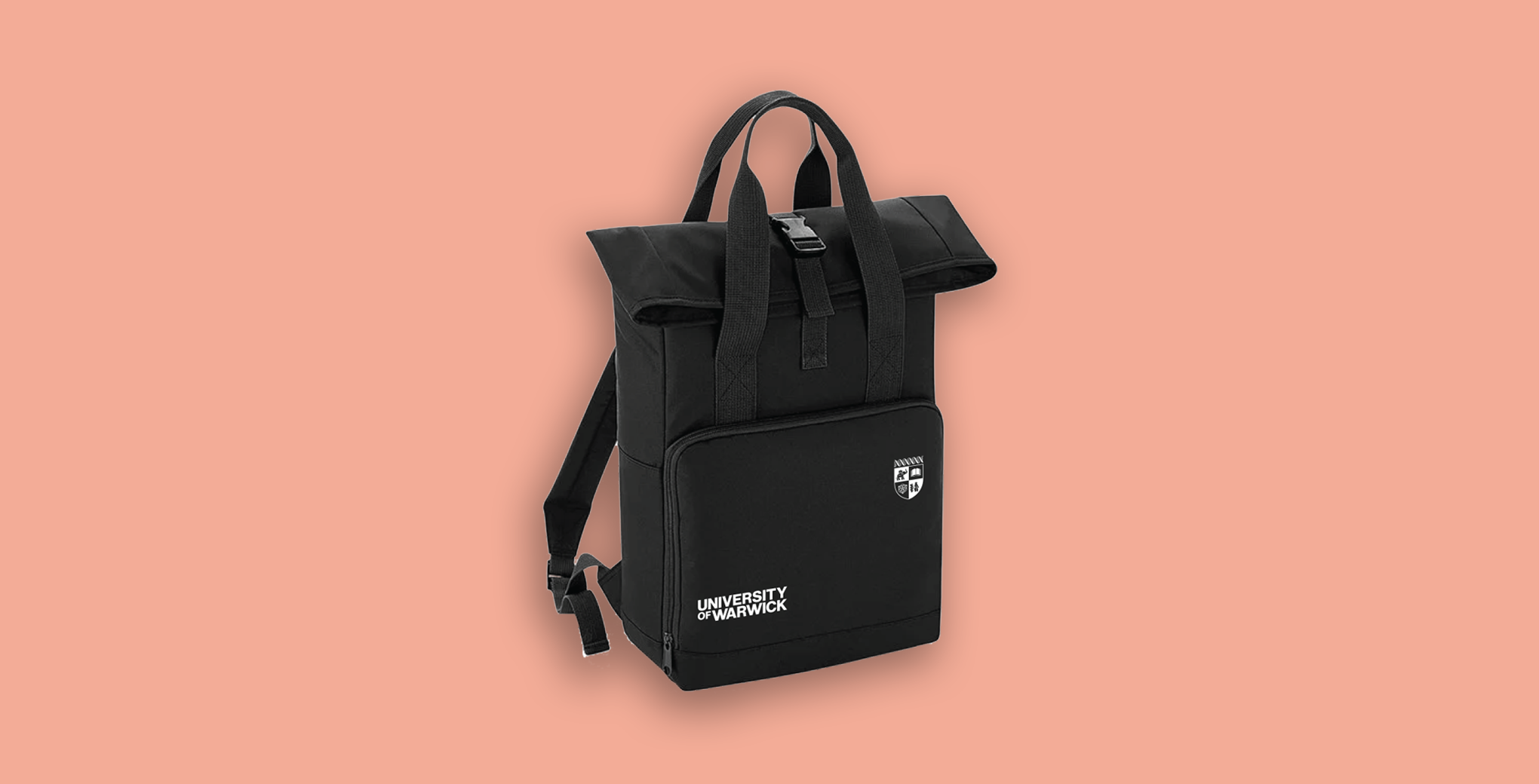 A black University of Warwick roll-top backpack with twin handles on the top and a front pocket with white printed University of Warwick logos, shown against a solid coral-pink background.