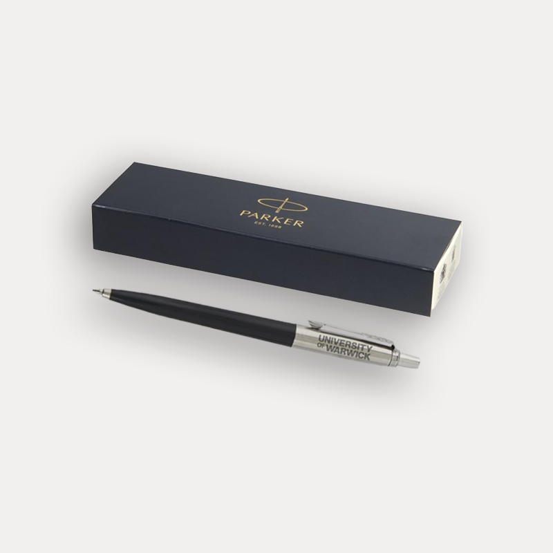 A black Parker London ballpoint pen with silver trim and 'UNIVERSITY OF WARWICK' printed on the barrel, displayed next to its presentation box with gold lettering on a light grey background.