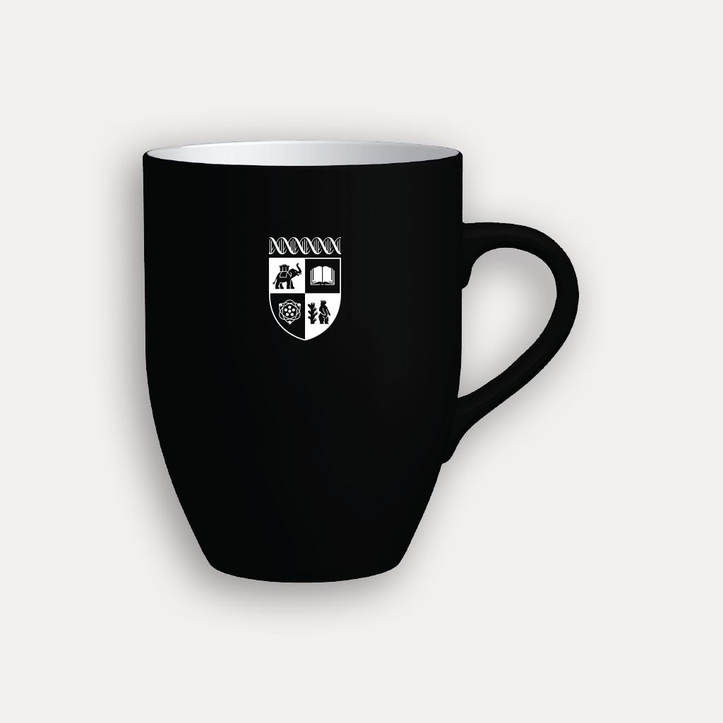 A black ceramic coffee mug with a white interior and a white printed shield crest on the front, shown against a light gray background.