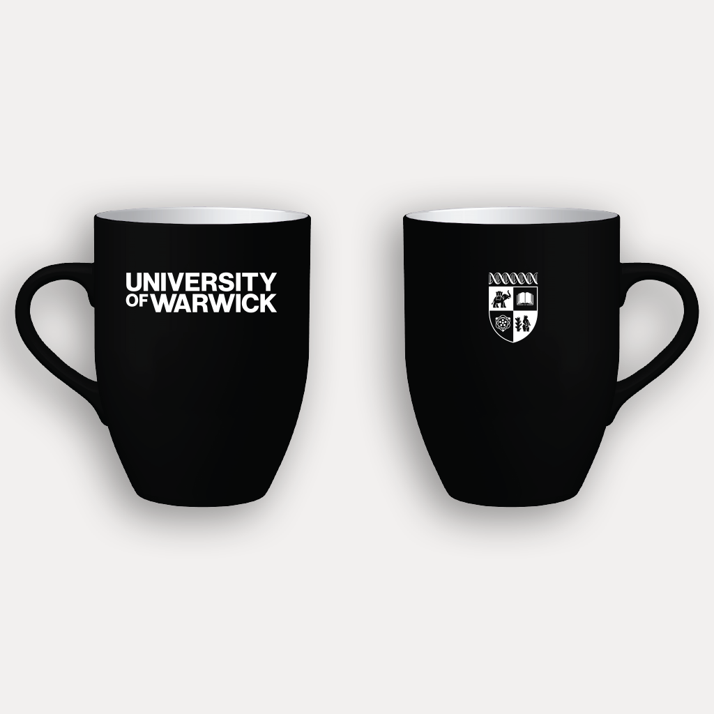 The front and back of a black ceramic mug shown on a light grey background, each with white printed graphics. The left mug reads 'UNIVERSITY OF WARWICK' and the right mug shows the University of Warwick crest.