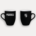 The front and back of a black ceramic mug shown on a light grey background, each with white printed graphics. The left mug reads 'UNIVERSITY OF WARWICK' and the right mug shows the University of Warwick crest.