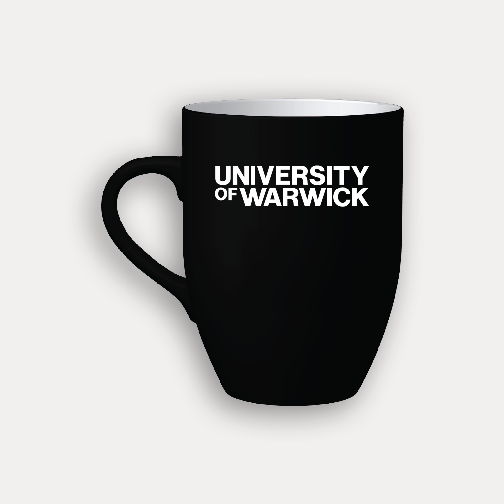 A black ceramic coffee mug with the words 'UNIVERSITY OF WARWICK' printed in bold white capital letters on the front, set against a light gray background.