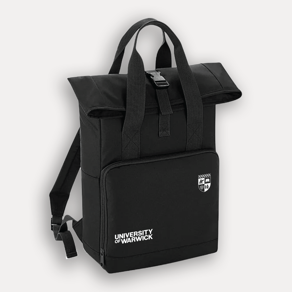 A black University of Warwick backpack with a rolltop, dual top handles, and a front pocket featuring the university's logo and text, shown on a light grey background.