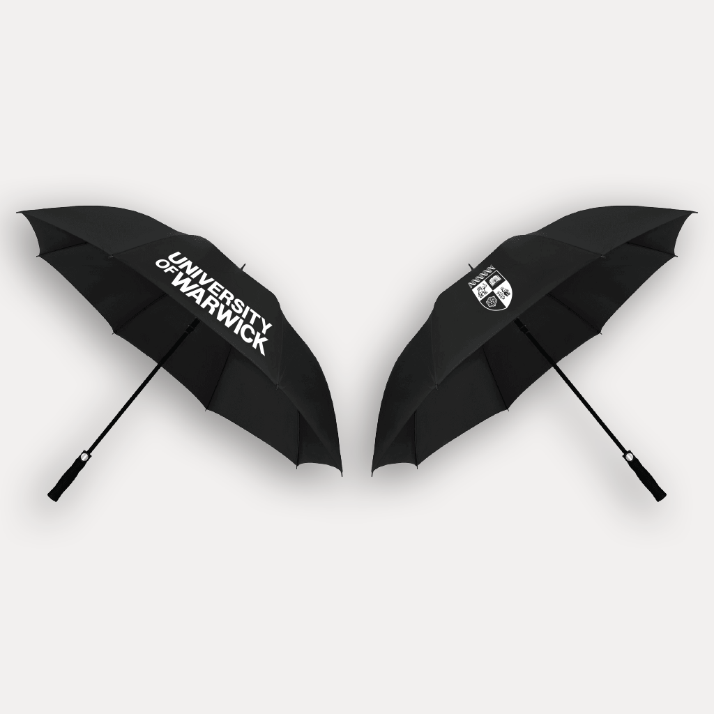 The front and back of a black University of Warwick branded umbrella shown side by side on a light grey background, one with the university name printed in white and the other with the university crest.