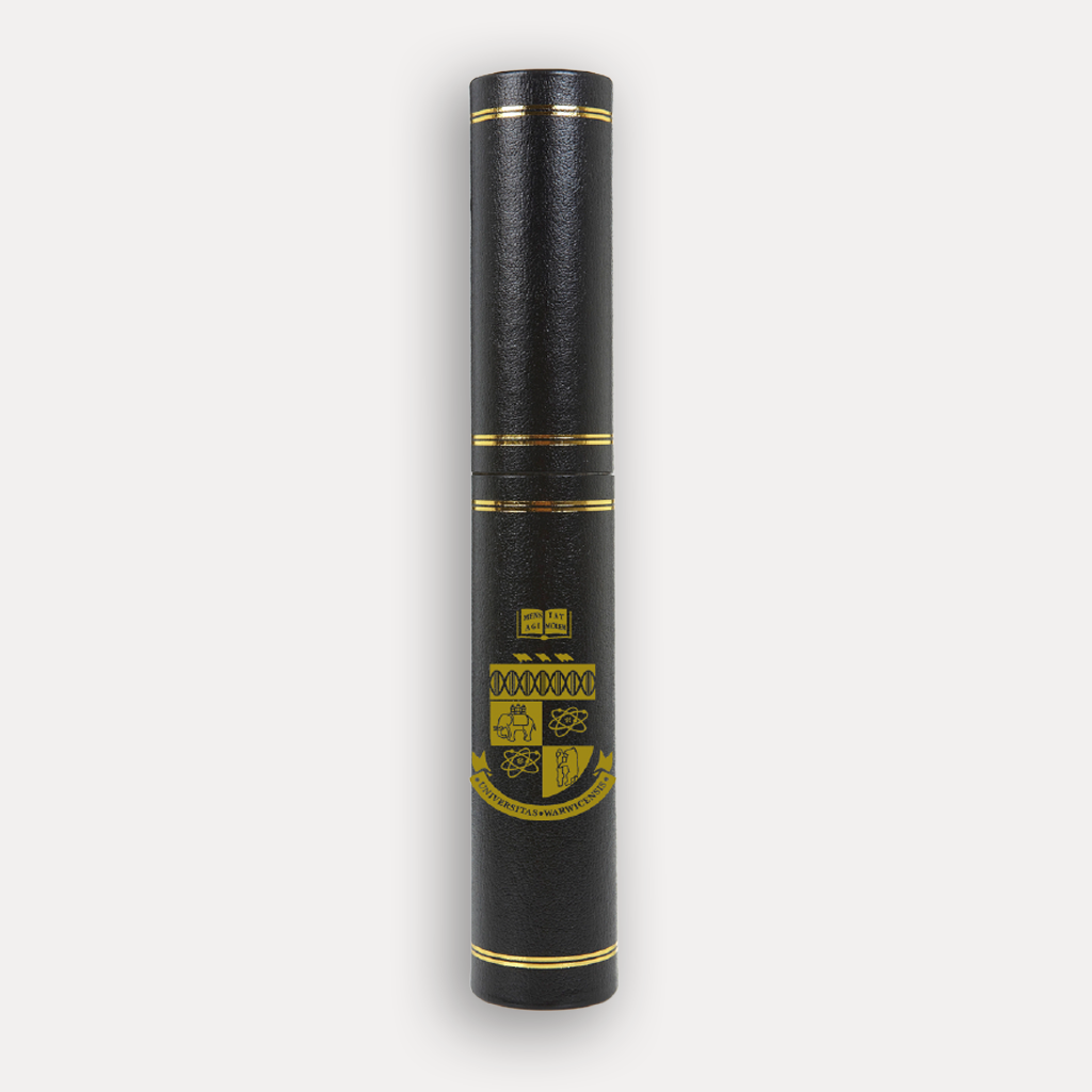 A black University of Warwick certificate holder with a gold ceremonial crest and stripes, shown on a light grey background.