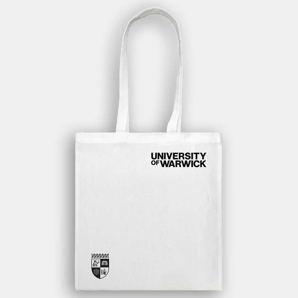 A white canvas tote bag with black printed text reading 'UNIVERSITY OF WARWICK' and a small black crest logo near the bottom left, shown against a light grey background.